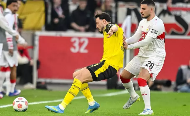 Stuttgart's Deniz Undav, right, and Dortmund's Ramy Bensebaïni in action during a German Bundesliga soccer match between VfB Stuttgart and Borussia Dortmund in Stuttgart, Germany, Saturday, April 4, 2026. (Harry Langer/dpa via AP)