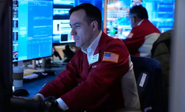 Robert Greason works on the floor at the New York Stock Exchange in New York, Tuesday, April 7, 2026. (AP Photo/Seth Wenig)