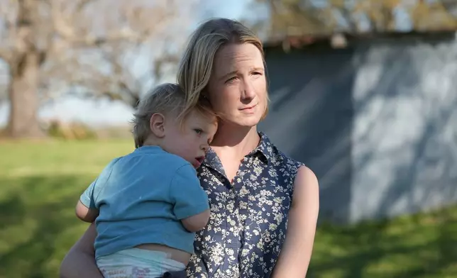 Helen Kaiser holds her son at their home in Landrum, S.C., on March 19, 2026. (AP Photo/Mary Conlon)