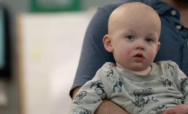 John Otwell holds his son, Arthur, at Miss Tammy's Little Learning Center in Landrum, S.C., on March 18, 2026. (AP Photo/Mary Conlon)