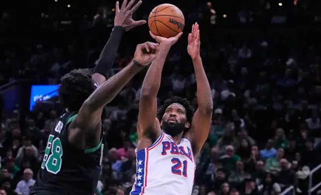 Philadelphia 76ers center Joel Embiid (21) takes a shot over Boston Celtics center Neemias Queta (88) during the second half of Game 5 of a first-round NBA playoffs basketball series, Tuesday, April 28, 2026, in Boston. (AP Photo/Charles Krupa)