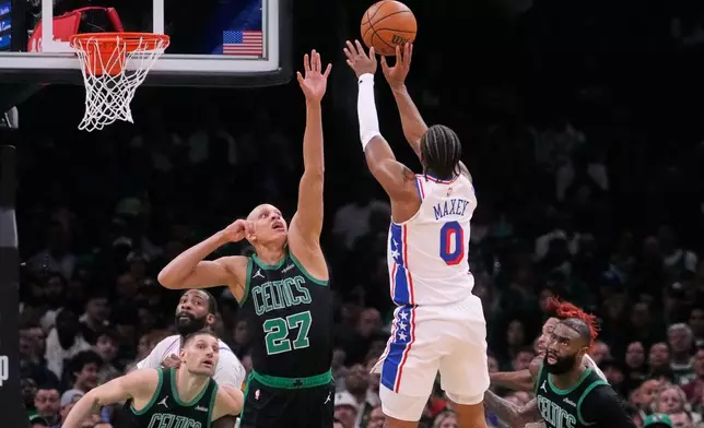 Philadelphia 76ers guard Tyrese Maxey (0) takes a shot over Boston Celtics guard Jordan Walsh (27) during the first half of Game 5 of a first-round NBA playoffs basketball series, Tuesday, April 28, 2026, in Boston. (AP Photo/Charles Krupa)