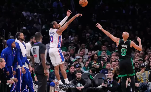 Philadelphia 76ers guard Tyrese Maxey (0) takes a 3-point shot over Boston Celtics guard Derrick White (9) during the first half of Game 5 of a first-round NBA playoffs basketball series, Tuesday, April 28, 2026, in Boston. (AP Photo/Charles Krupa)
