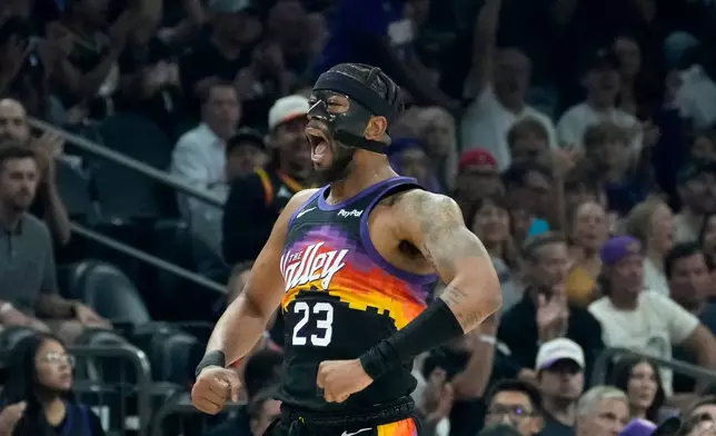 Phoenix Suns guard Jordan Goodwin celebrates a made 3-pointer against the Houston Rockets during the first half of an NBA basketball game, Tuesday, April 7, 2026, in Phoenix. (AP Photo/Ross D. Franklin)