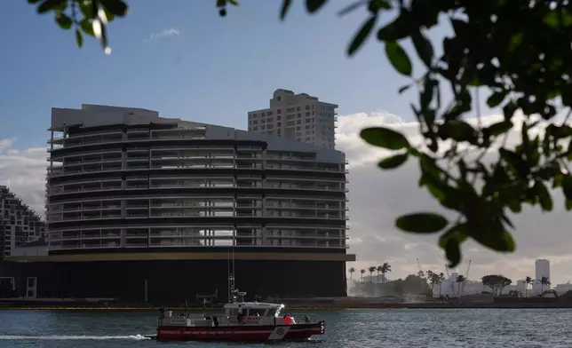 A City of Miami Fire-Rescue boat patrols in front of the former Mandarin Oriental Hotel on Brickell Key ahead of its controlled implosion, Sunday, April 12, 2026, in Miami. (AP Photo/Rebecca Blackwell)