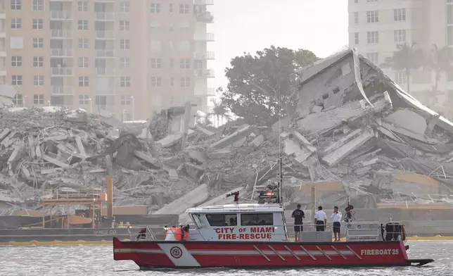 A Miami Fire-Rescue boat surveys debris following the controlled implosion of the former Mandarin Oriental Hotel on Brickell Key, Sunday, April 12, 2026, in Miami. (AP Photo/Rebecca Blackwell)