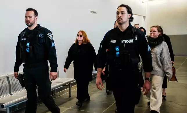 Asa Ellerup, center left, wife, of Rex Heuermann and Victoria Heuermann, right, walk the hallway after departs the courtroom as Rex Heuermann, accused in Long Island's infamous Gilgo Beach serial killings, pleaded guilty on Wednesday, April 8, 2026, at Suffolk County Court in Riverhead, New York. (AP Photo/Eduardo Munoz Alvarez)