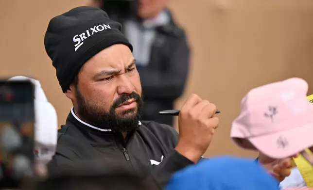 J.J. Spaun signs autographs after the fourth round of the Valero Texas Open golf tournament in San Antonio, Sunday, April 5, 2026. (AP Photo/Darren Abate)