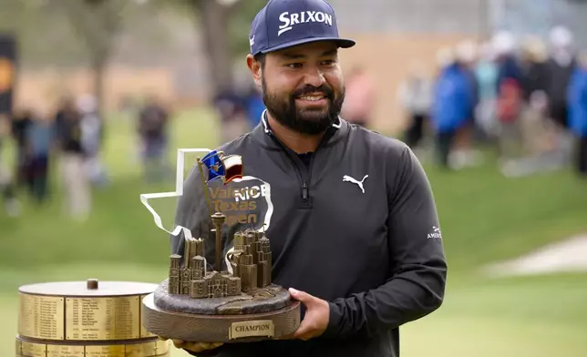 J.J. Spaun holds the championship trophy after winning the Valero Texas Open golf tournament in San Antonio, Sunday, April 5, 2026. (AP Photo/Darren Abate)