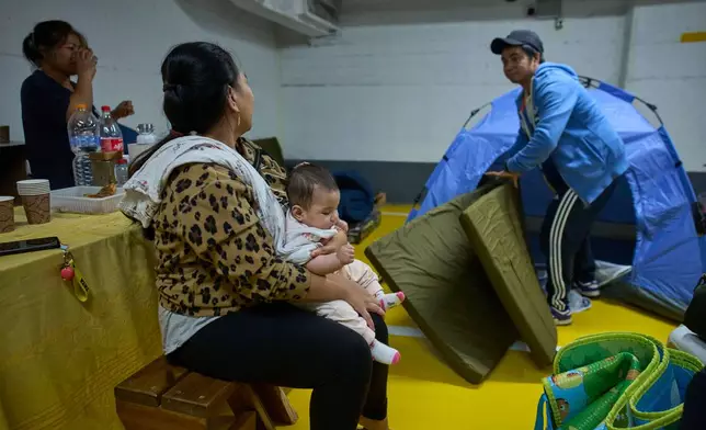 People residing in an underground shelter pack up their belongings as they prepare to leave after the announcement of a two-week ceasefire agreement between Iran and the US, in Tel Aviv, Israel, Thursday, April 9, 2026. (AP Photo/Ohad Zwigenberg)