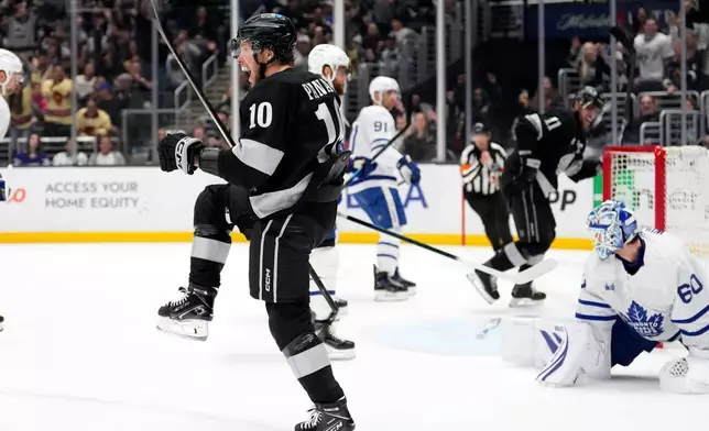 Los Angeles Kings left wing Artemi Panarin, left, celebrates after scoring on Toronto Maple Leafs goaltender Joseph Woll during the second period of an NHL hockey game Saturday, April 4, 2026, in Los Angeles. (AP Photo/Mark J. Terrill)