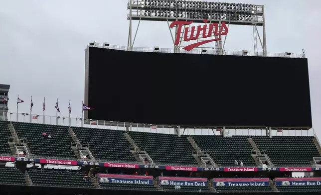 The scoreboard is blank due to a power outage before the Minnesota Twins' home-opener baseball game against the Tampa Bay Rays, Friday, April 3, 2026, in Minneapolis. (AP Photo/Ellen Schmidt)