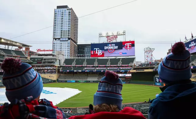 Fans wear Minnesota Twins hats before the team's home-opener baseball game against the Tampa Bay Rays, Friday, April 3, 2026, in Minneapolis. (AP Photo/Ellen Schmidt)