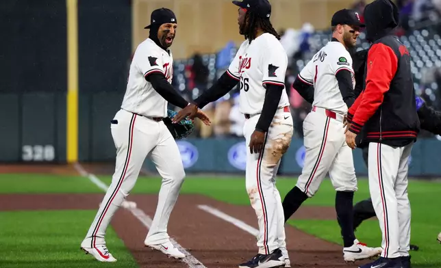 Minnesota Twins third baseman Royce Lewis, left, celebrates with first baseman Josh Bell (56) after their team won a baseball game against the Tampa Bay Rays, Friday, April 3, 2026, in Minneapolis. (AP Photo/Ellen Schmidt)