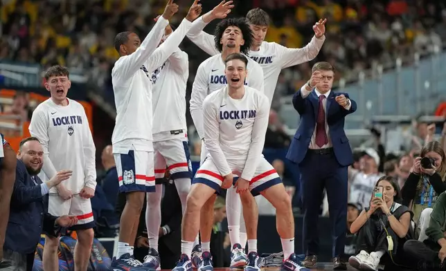Members of UConn celebrate during the second half of an NCAA college basketball tournament semifinal game against Illinois at the Final Four, Saturday, April 4, 2026, in Indianapolis. (AP Photo/Michael Conroy)