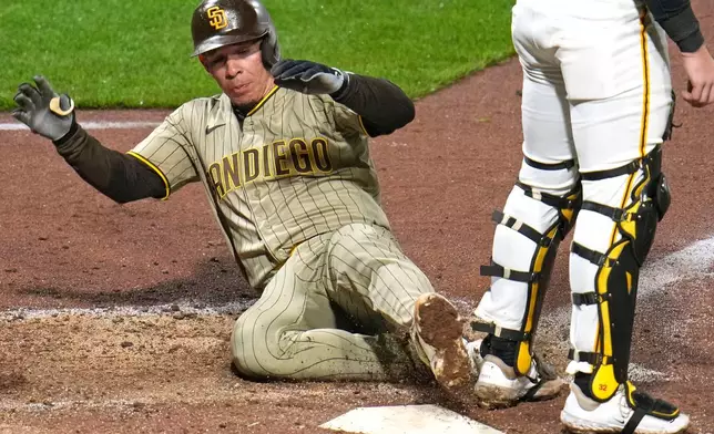 San Diego Padres' Freddy Fermin, left, scores behind Pittsburgh Pirates catcher Henry Davis, right, on a double by Padres' Ramón Laureano off Pirates pitcher Justin Lawrence during the eighth inning of a baseball game in Pittsburgh, Monday, April 6, 2026. (AP Photo/Gene J. Puskar)