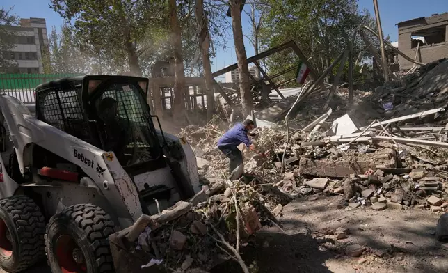 Workers remove debris at Tehran's Sharif University of Technology complex that Iranian authorities say was hit early Monday by a U.S.-Israeli strike, in Tehran, Iran, Monday, April 6, 2026. (AP Photo/Francisco Seco)
