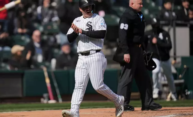 Chicago White Sox's Chase Meidroth (10) scores on a single by Lenyn Sosa during the third inning of a baseball game against the Baltimore Orioles, Tuesday, April 7, 2026, in Chicago. (AP Photo/Erin Hooley)