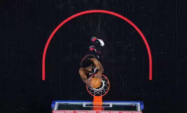 Philadelphia 76ers' Joel Embiid goes up for a dunk during the first half of Game 4 against the Boston Celtics in a first-round NBA basketball playoffs series Sunday, April 26, 2026, in Philadelphia. (AP Photo/Matt Slocum)