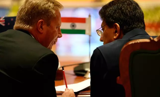 New Zealand Trade Minister Todd McClay, left, talks with Indian Commerce Minister Piyush Goyal during the India New Zealand Free Trade Agreement signing ceremony and Business forum meeting in New Delhi, India, Monday, April 27, 2026. ( AP Photo/Manish Swarup)
