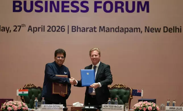 Todd McClay, New Zealand Minister for Trade and Investment shakes hand with Indian Commerce Minister Piyush Goyal following the India New Zealand Free Trade Agreement signing ceremony and Business forum meeting in New Delhi, India, Monday, April 27, 2026. ( AP Photo/Manish Swarup)