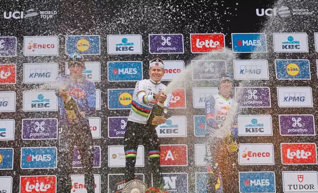 Slovenia's Tadej Pogacar celebrates after winning the Tour of Flanders cycling race, with Netherland's Mathieu Van Der Poel, left, finishing second and Belgium's Remco Evenpoel third in Oudenaarde, Belgium Sunday, April 5, 2026. (AP Photo/Geert Vanden Wijngaert))