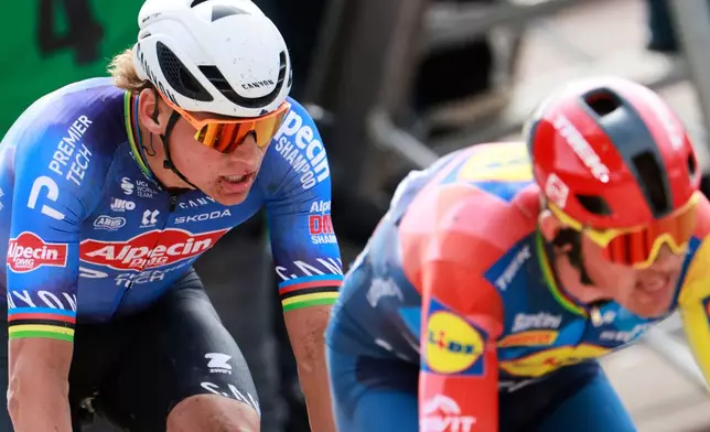 Netherlands' Mathieu van der Poel, left, follows Mads Pedersen of Denmark, right, to take a fourth place in the Paris-Roubaix cycling race in Roubaix, France, Sunday, April 12, 2026. (AP Photo/Jean-Francois Badias)