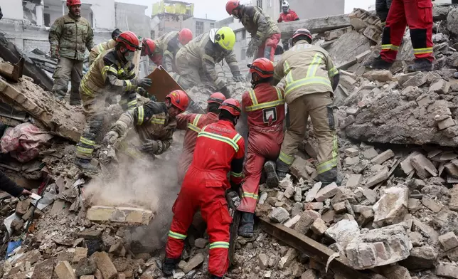 FILE - Rescue workers search for survivors in the rubble after a strike in southern Tehran, Iran, March 13, 2026. (AP Photo/Sajjad Safari, File)