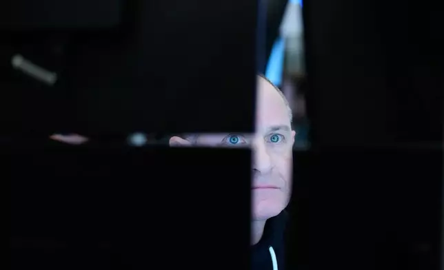 FILE - People work on the floor at the New York Stock Exchange in New York, March 18, 2026. (AP Photo/Seth Wenig, File)