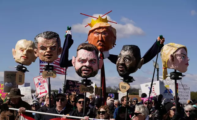 FILE - EDS NOTE: OBSCENITY - Demonstrators march near the Memorial Bridge during the No Kings protest in Washington, March 28, 2026. (AP Photo/Jose Luis Magana, File)