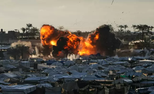 FILE - Smoke and flames rise from an Israeli military strike on a target next to a tent camp in Deir al-Balah, central Gaza Strip, March 25, 2026. (AP Photo/Abdel Kareem Hana, File)