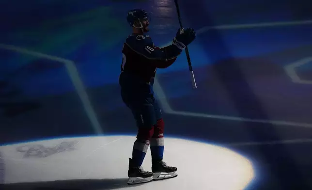 Colorado Avalanche center Nicolas Roy (10) waves to the crowd while being recognized as the player of the game after scoring the game winning goal against the Los Angeles Kings in overtime of Game 2 in the first round of the NHL hockey Stanley Cup playoffs, Tuesday, April 21, 2026, in Denver. (AP Photo/Jack Dempsey)