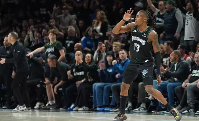 Minnesota Timberwolves guard Ayo Dosunmu (13) celebrates after making a 3-point basket during the first half of Game 4 of a first-round NBA basketball playoff series against the Denver Nuggets, Saturday, April 25, 2026, in Minneapolis. (AP Photo/Abbie Parr)