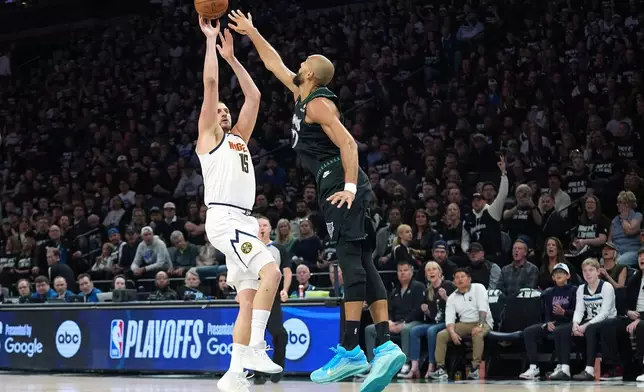 Denver Nuggets center Nikola Jokic (15) shoots over Minnesota Timberwolves center Rudy Gobert (27) during the first half of Game 4 of a first-round NBA basketball playoff series, Saturday, April 25, 2026, in Minneapolis. (AP Photo/Abbie Parr)