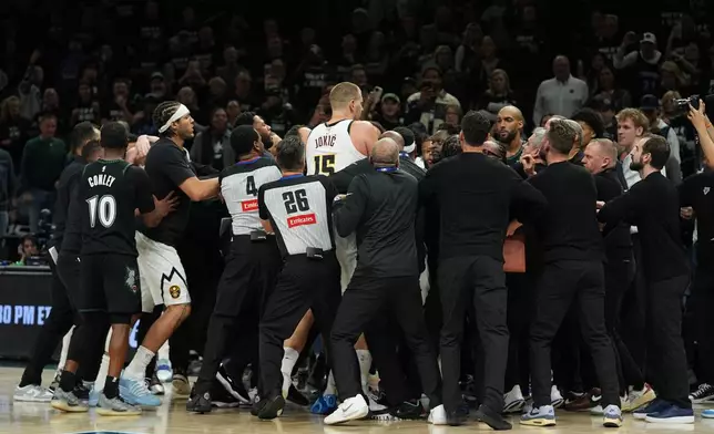 Minnesota Timberwolves and Denver Nuggets players get into an altercation during the second half of Game 4 of a first-round NBA basketball playoff series, Saturday, April 25, 2026, in Minneapolis. (AP Photo/Abbie Parr)