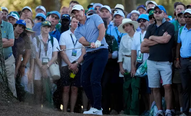 Rory McIlroy, of Northern Ireland, hits from the pine straw on the 17th hole during the third round of the Masters golf tournament at the Augusta National Golf Club, Saturday, April 11, 2026, in Augusta, Ga. (AP Photo/Gerald Herbert)