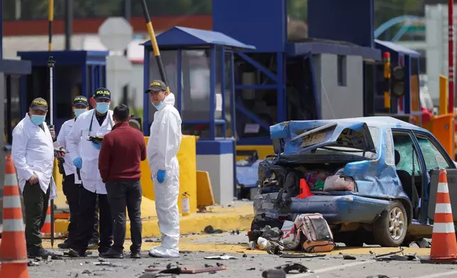 Forensics inspect the scene of a fatal, multiple vehicle accident in Cogua, Colombia, Wednesday, April 1, 2026. (AP Photo/Ivan Valencia)