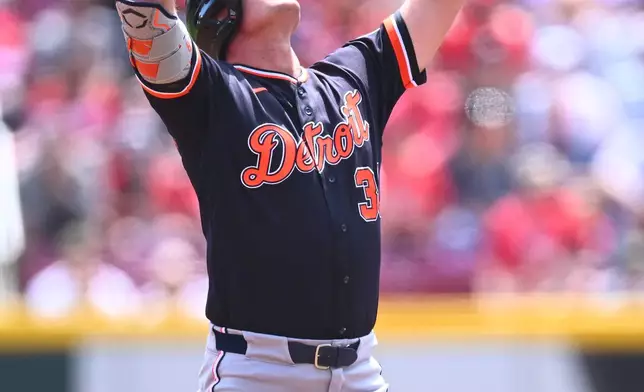 Detroit Tigers' Kerry Carpenter reacts after hitting an RBI double during the first inning of a baseball game against the Cincinnati Reds in Cincinnati, Sunday, April 26, 2026. (AP Photo/Ben Jackson)