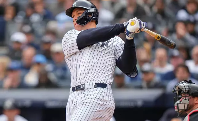 New York Yankees' Aaron Judge (99) hits a two-run home run during the first inning of the Yankees' home-opener baseball game against the Miami Marlins, Friday, April 3, 2026, in New York. (AP Photo/Yuki Iwamura)