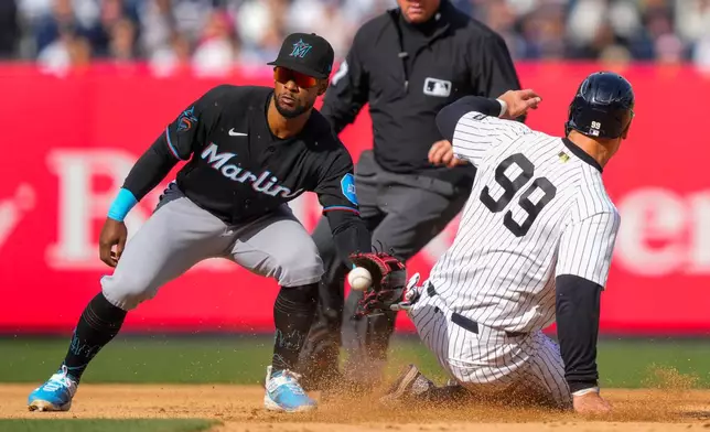 New York Yankees' Aaron Judge (99) successfully steals second base during the eighth inning of a home-opener baseball game against the Miami Marlins, Friday, April 3, 2026, in New York. (AP Photo/Yuki Iwamura)