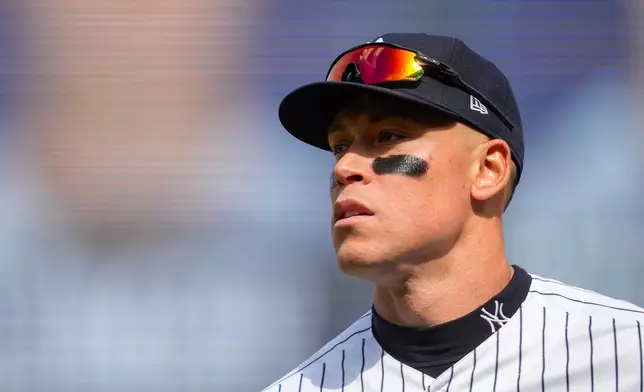New York Yankees right fielder Aaron Judge (99) walks back to dugout during the fifth inning of a home-opener baseball game against the Miami Marlins, Friday, April 3, 2026, in New York. (AP Photo/Yuki Iwamura)