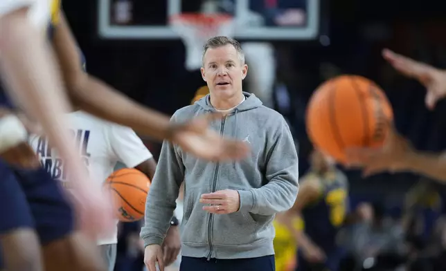 Michigan head coach Dusty May watches during practice ahead of an NCAA college basketball tournament semifinal game against Arizona at the Final Four, Friday, April 3, 2026, in Indianapolis. (AP Photo/Michael Conroy)