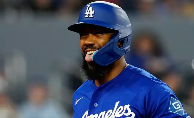 Los Angeles Dodgers' Teoscar Hernández celebrates after scoring on a two-run home run against the Toronto Blue Jays during first-inning baseball game action in Toronto, Monday, April 6, 2026. (Frank Gunn/The Canadian Press via AP)