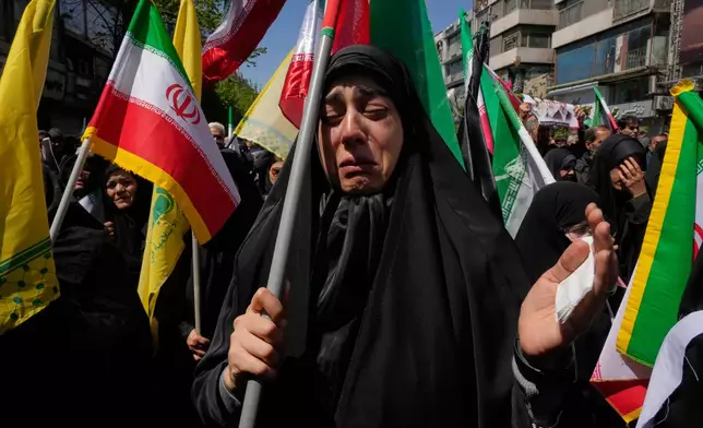 A government supporter weeps during a mourning ceremony marking the 40th day since the death of Iranian Supreme Leader Ayatollah Ali Khamenei, who was killed in the U.S. and Israel strikes in Tehran, Iran, Thursday, April 9, 2026. (AP Photo/Vahid Salemi)
