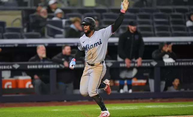 Miami Marlins' Otto Lopez reacts as he scores on a double hit by Graham Pauley during the eighth inning of a baseball game against the New York Yankees, Sunday, April 5, 2026, in New York. (AP Photo/Seth Wenig)