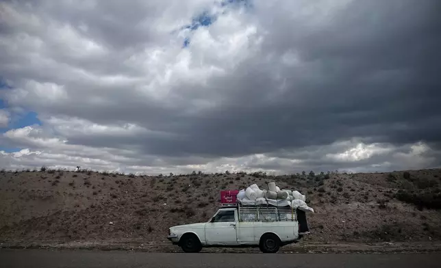 A pickup truck loaded with bundled fabric is parked along Road 2 between Zanjan and Tabriz, Iran, Thursday, April 9, 2026. (AP Photo/Francisco Seco)