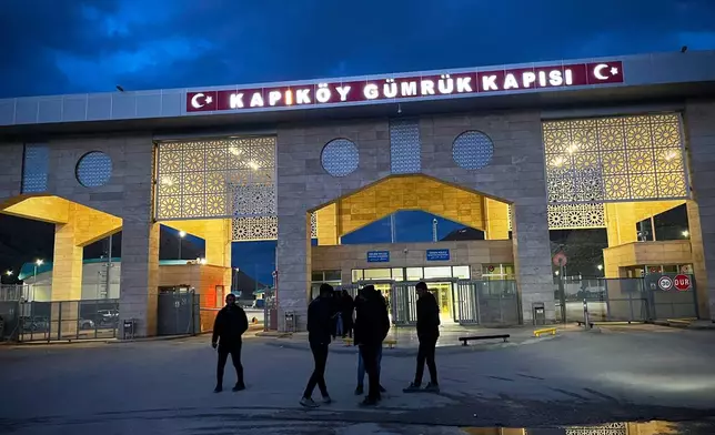 People wait for travellers coming from Iran at the Kapikoy border checkpoint, Turkey, Thursday, April 9, 2026. (AP Photo/Francisco Seco)