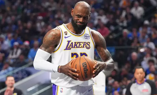 Los Angeles Lakers forward LeBron James grimaces as he grabs the ball after a whistle during the first half of an NBA basketball game against the Dallas Mavericks in Dallas, Sunday, April 5, 2026. (AP Photo/LM Otero)