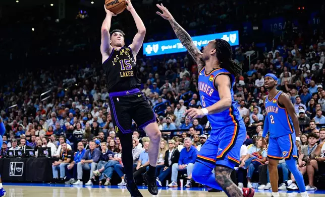 Los Angeles Lakers guard Austin Reaves (15) shoots against Oklahoma City Thunder forward Jaylin Williams (6) during the first half of an NBA basketball game Thursday, April. 2, 2026, in Oklahoma City. (AP Photo/Gerald Leong)