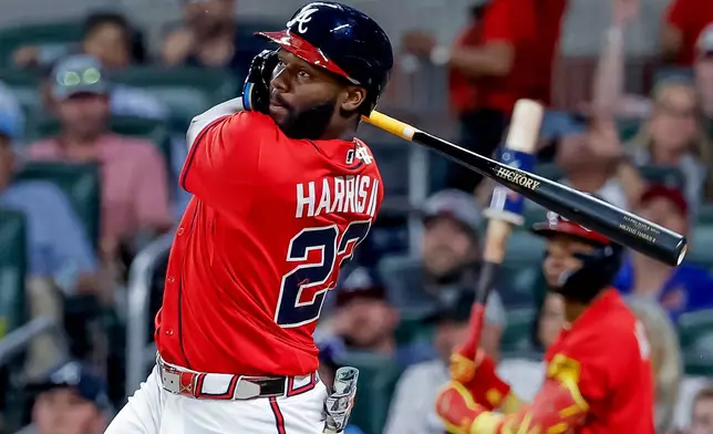 Atlanta Braves pinch hitter Michael Harris II (23) follows through on a two-RBI double against the Philadelphia Phillies during the sixth inning of a baseball game, Friday, April 24, 2026, in Atlanta. (AP Photo/Erik S. Lesser)